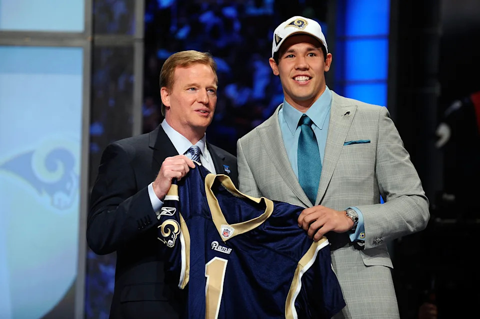 NEW YORK - APRIL 22: Quarterback Sam Bradford of the Oklahoma Sooners holds up a St. Louis Rams jersey as he stands with NFL Commissioner Roger Goodell after Bradford was picked numer 1 overall by the Rams during the 2010 NFL Draft at Radio City Music Hall on April 22, 2010 in New York City. (Photo by Jeff Zelevansky/Getty Images)