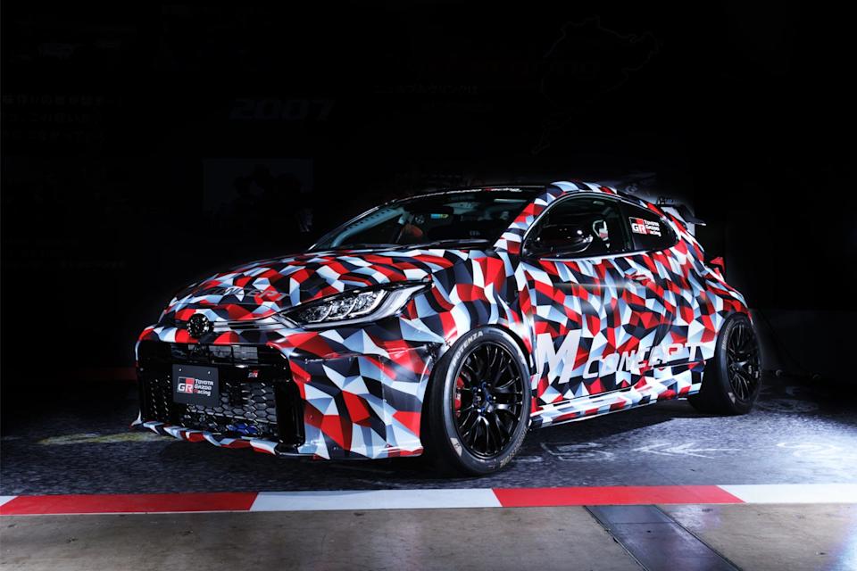 concept car with colorful geometric camouflage design in a racing environment