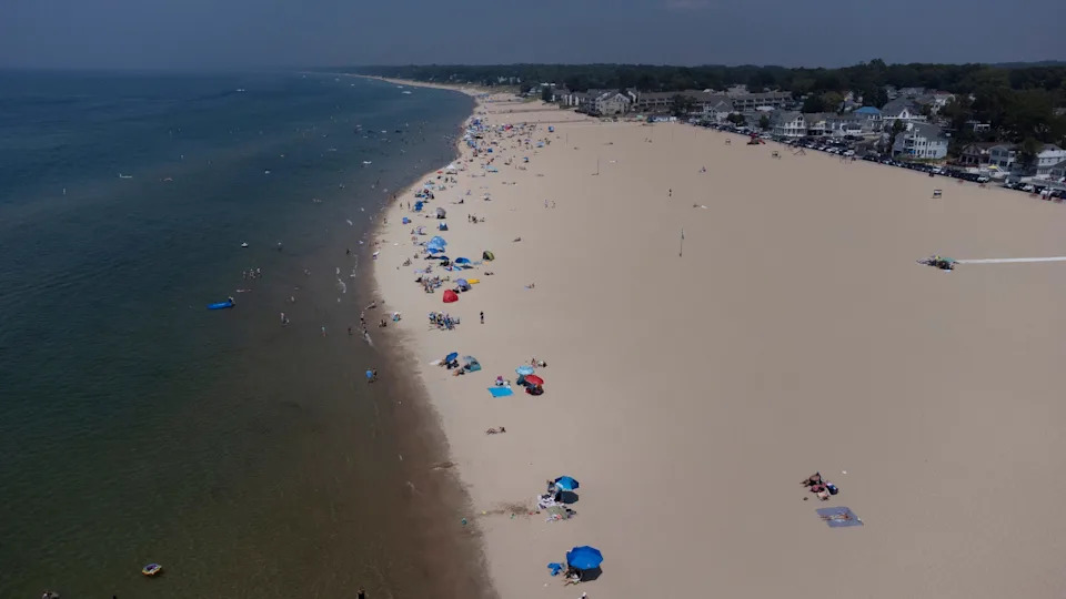 Beachgoers in South Haven swim in Lake Michigan at their own risk on Tuesday, July 15, 2025. Lake Michigan is the deadliest lake in America, statistics show. Yet there are no lifeguards at 99% of Michigan's public beaches.