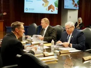Oklahoma State Board of Education members, from left, Mike Tinney, Ryan Deatherage and Chris Van Denhende review their board packets before a meeting April 24 at the Oklahoma State Department of Education in Oklahoma City. (Photo by Nuria Martinez-Keel/Oklahoma Voice)