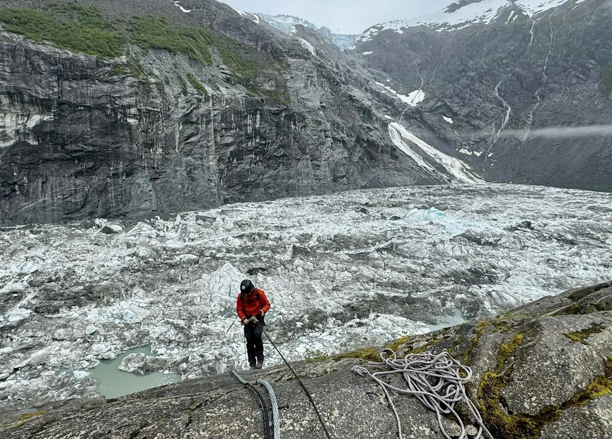 U.S. Geological Survey staff check monitoring equipment in Suicide Basin in June 2025. By August, the basin had filled with meltwater. <a href="https://www.usgs.gov/news/state-news-release/usgs-measures-glacial-flooding-juneau-alaska" rel="nofollow noopener" target="_blank" data-ylk="slk:Jeff Conaway/U.S. Geological Survey;elm:context_link;itc:0;sec:content-canvas" class="link ">Jeff Conaway/U.S. Geological Survey</a>