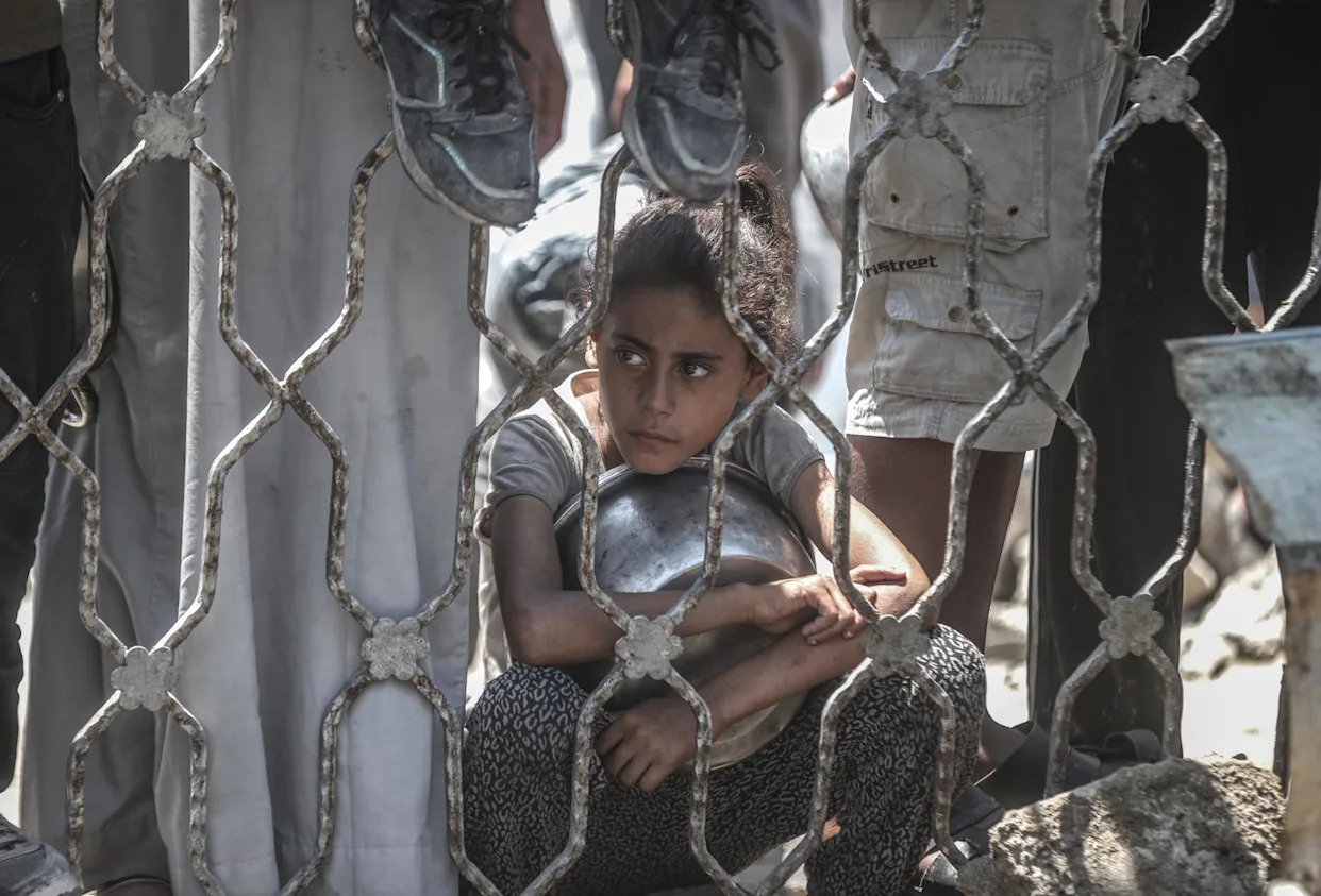 <span>A charity distributes meals to Palestinians facing food shortages amid ongoing Israeli attacks and severe restrictions in Gaza City, Gaza, on Monday.</span><span>Photograph: Anadolu/Getty Images</span>