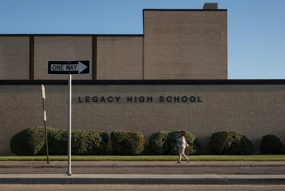 A Midland ISD employee walks past the front of Legacy High School on Thursday, Aug. 7, 2025, in Midland.