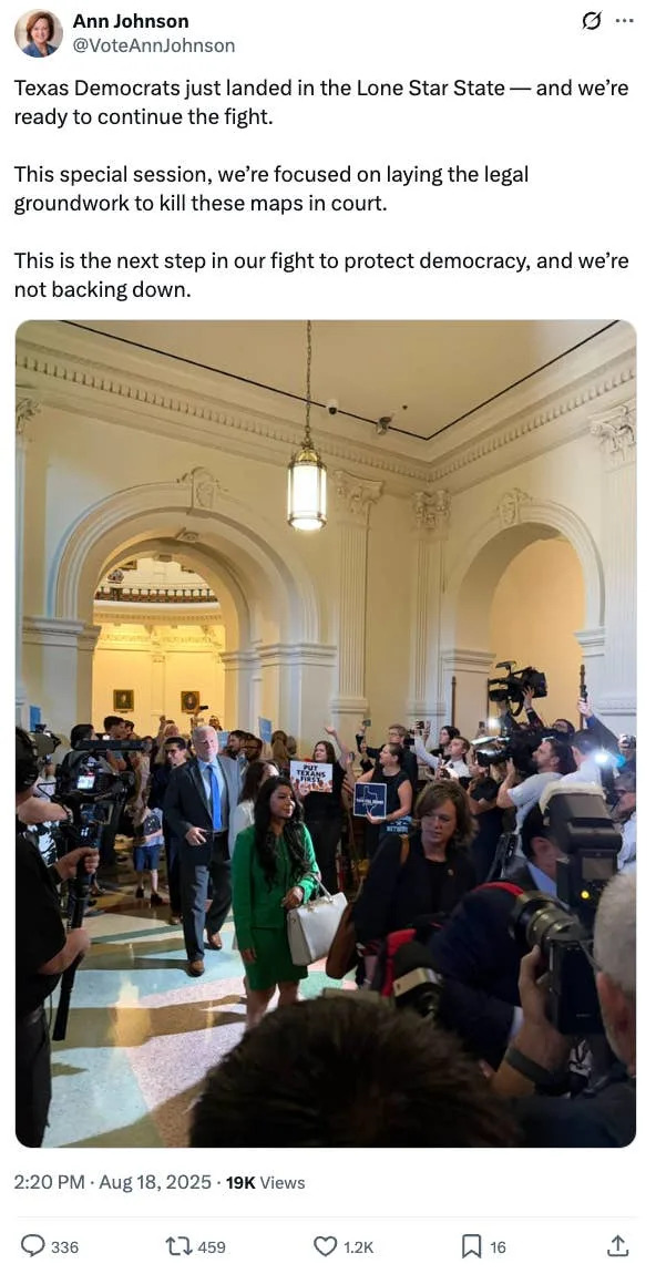 Crowd of people, including press and officials, gathered inside a grand building for a Texas Democrats event focused on legal challenges
