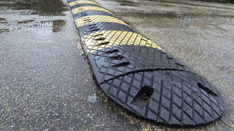 A plastic speed hump on a rainy street