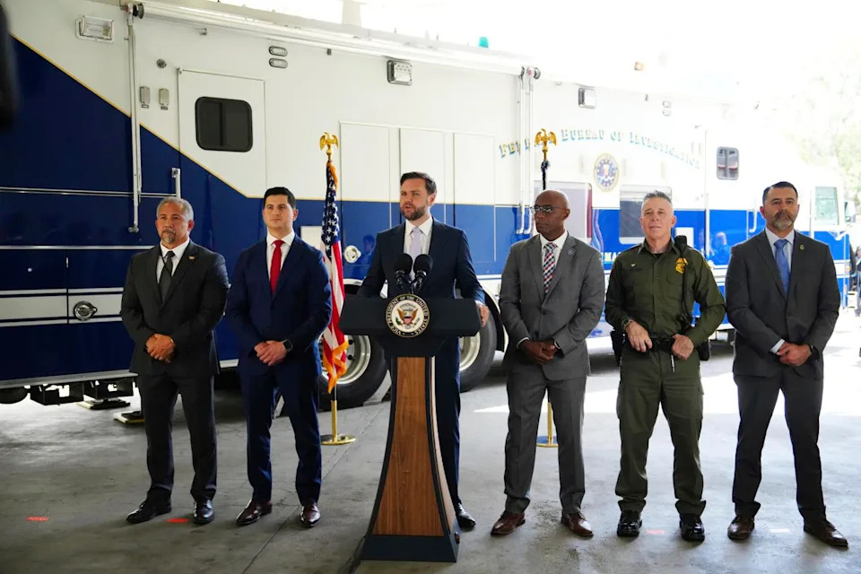 Vice President JD Vance, center, speaks next to officials at the Wilshire Federal Building