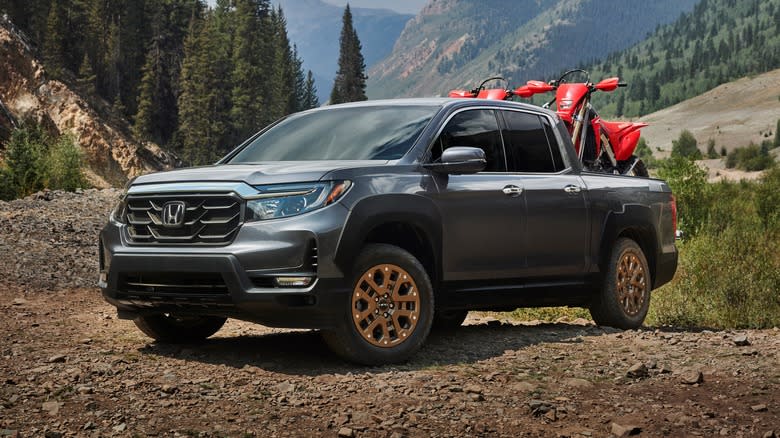2021 Honda Ridgeline parked off-road with trees and mountains in the