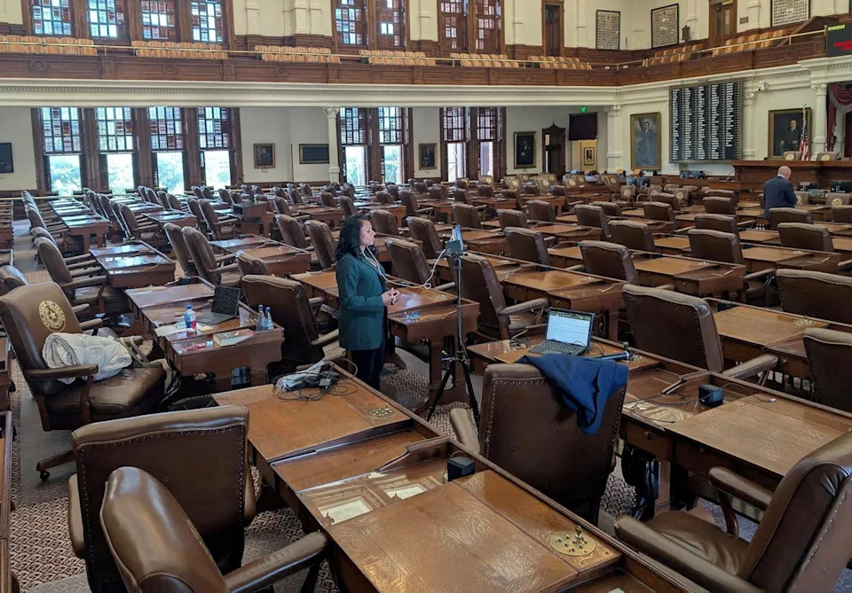Gene Wu via Reuters - PHOTO: State Rep. Nicole Collier talks on the phone from the floor of the House after Democratic lawmakers who had left the state to prevent Republicans from redrawing Texas's 38 congressional districts returned to the Capitol in Austin, Aug. 18, 2025.