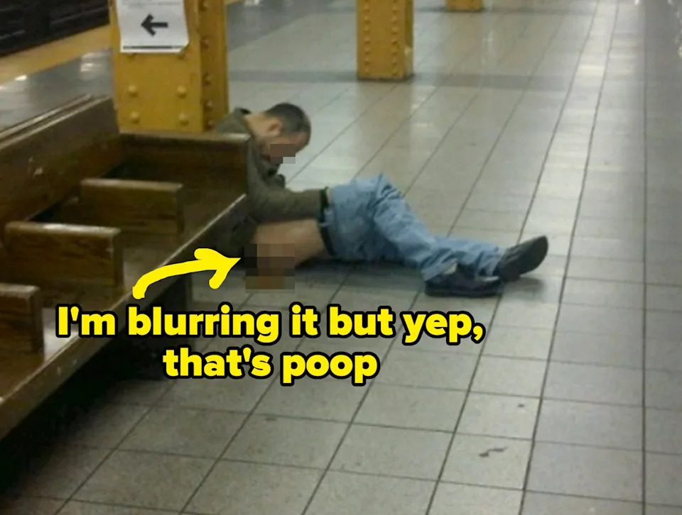 Person lying on subway platform floor, appearing asleep with pants partially down, pooping