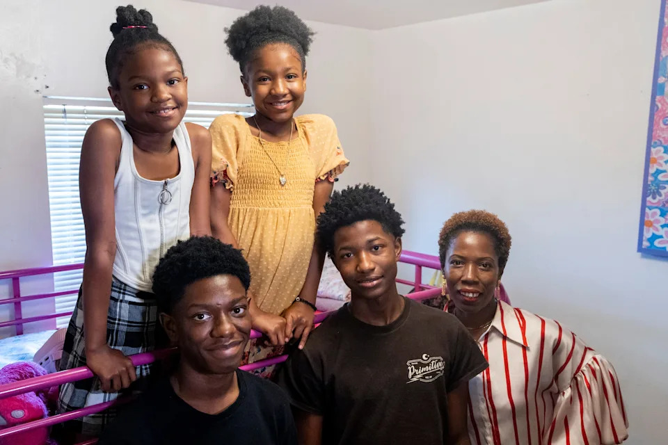 Abiodun Ogunwale, 8, Negasi Ogunwale, 16, Ifawemimo Ogunwale, 10, Kalonji Ogunwale, 18, and their mother Iyalaje Ogunwale pose for a portrait in the room shared by the girls in Memphis, Tenn., on June 28, 2025.