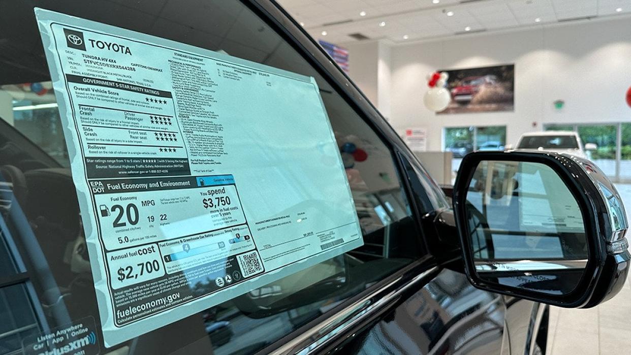 A car dealer&#39;s pricing sticker on a Toyota Tundra vehicle. - Kenishirotie // Shutterstock