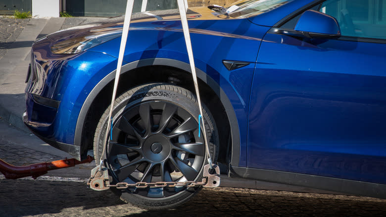 Tesla vehicle on lift being repaired