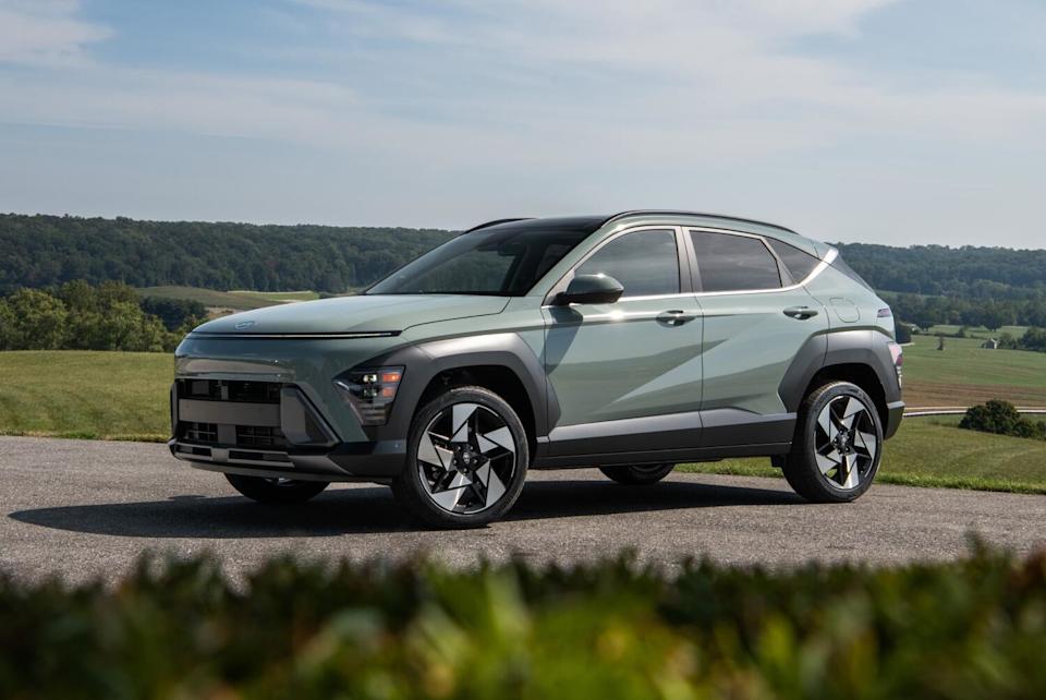A pale blue-green vehicle in a green landscape