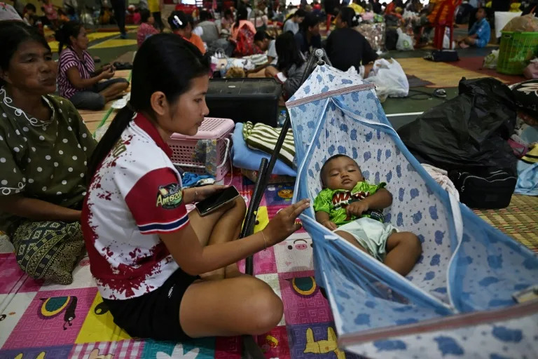Thousands of people in Thailand's northeastern Surin province fled their homes and sought refuge in makeshift shelters (Lillian SUWANRUMPHA)