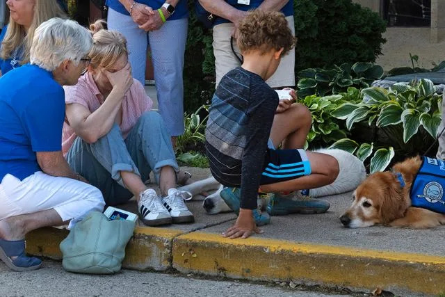 Scott Olson/Getty People gather outside Annunciation Catholic Church on August 28, 2025