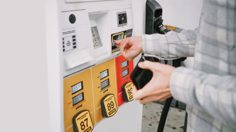 A customer using a card for paying gas