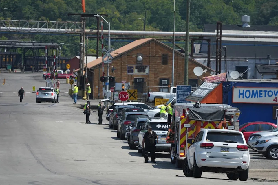 Emergency crew gather after an explosion at the Clairton Coke Works, a U.S. Steel coking plant, Monday, Aug 11, 2025, in Clairton, Penn. (AP Photo/Gene Puskar)
