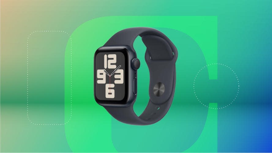 Black Apple Watch with watchface/numbers on screen displayed against a gradient green and purple background