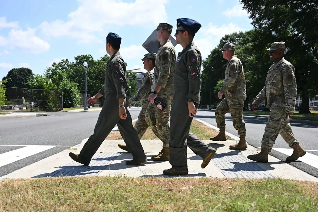 <span>Members of the national guard walk from the DC joint force headquarters to the DC Armory in Washington, DC, on Tuesday.</span><span>Photograph: Jim Watson/AFP/Getty Images</span>
