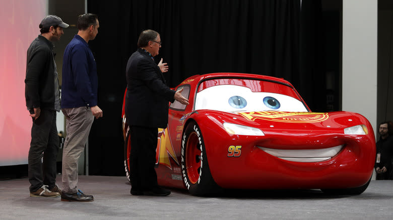 John Lasseter (R), Chief Creative Officer of Pixar Animation Studios, Jay Ward (C), Creative Director, and Jay Shuster (L), Production Designer, debut a life-size version of Lightning McQueen, one of the stars of the new Pixar movie "Cars 3" at the 2017 North American International Auto Show on January 8, 2017 in Detroit, Michigan.