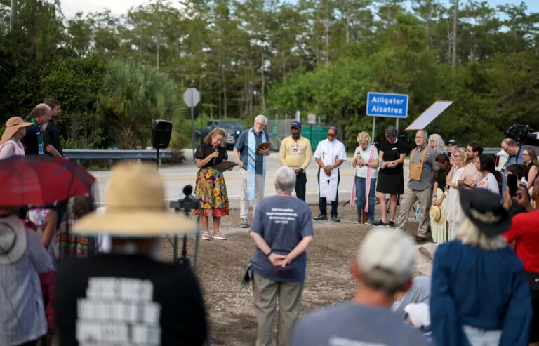 A prayer vigil near the entrance to the state-managed immigration detention center dubbed Alligator Alcatraz. (Photo by Joe Raedle/Getty Images)