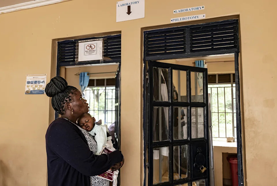 A mother living with HIV since 2017 visits Kuoyo Sub-county Hospital with her child to collect their medications, on April 24, 2025 in Kisumu, Kenya. | Michel Lunanga/Getty Images