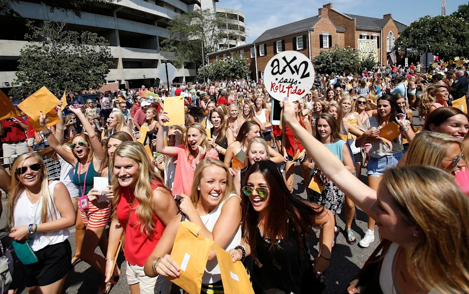 Girls run to their prospective sorority houses after opening their bids in Bryant-Denny Stadium in Tuscaloosa, Ala. on Saturday Aug. 16, 2014. Approximately 2,300 girls participated in the University of Alabama's fall recruitment.  staff photo | Erin Nelson