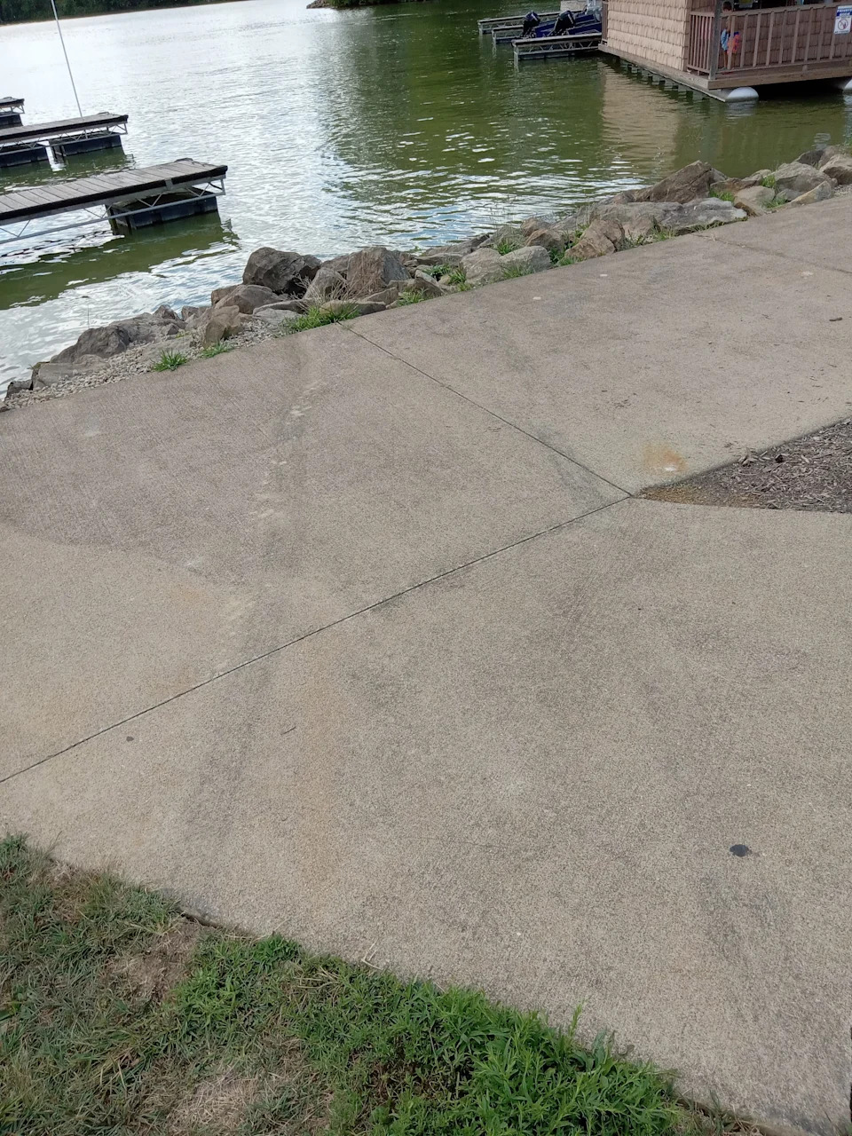 Skid marks are shown on the sidewalk at Atwood Lake Marina West, where a woman drove a golf cart into the water on Aug. 23. She and her three teenage children survived, but her husband, 45, and son, 4, were found dead in another area of the lake.