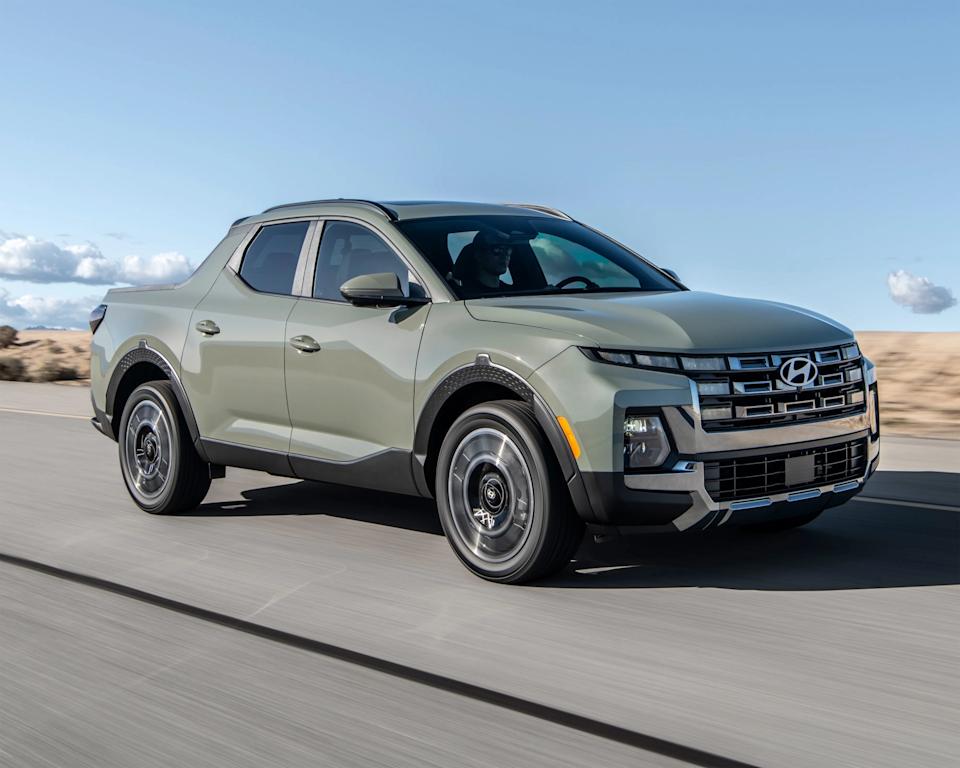 a photo of a grey hyundai santa cruz driving
