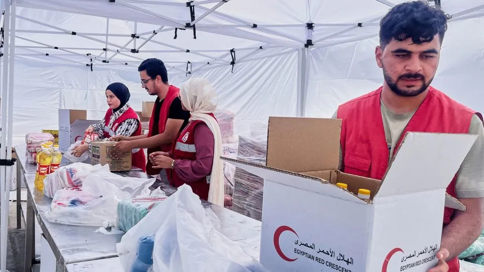 Egyptian Red Crecent members prepare humanitarian aid at their warehouse in the logistical center supporting Gaza, at Sheikh Zuweid, Egypt, on Monday. - Mayar Mokhtar/AP