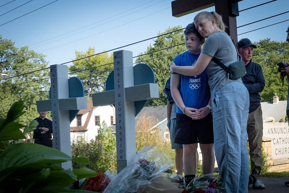 Scott Olson/Getty Images - PHOTO: People visit a memorial to yesterday's shooting victims in front of Annunciation Catholic Church on August 28, 2025 in Minneapolis, Minnesota.