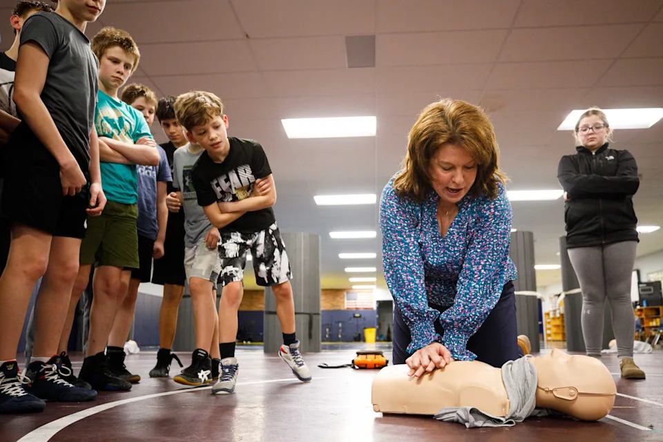 Tonya Aerts, a biomedical science teacher at New Prairie High School, leads a training session for the New Prairie Middle School wrestling team on how to perform CPR and use an automated external defibrillator (AED) at New Prairie High School on Tuesday, Feb. 11, 2025, in New Prairie.