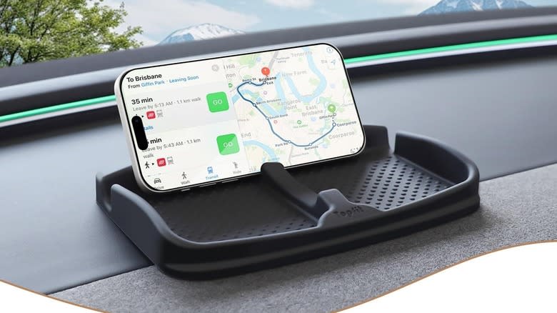 The ThinSGO Anti-Slip Car Dash Grip Pad mounted to a dashboard with a phone resting in it.