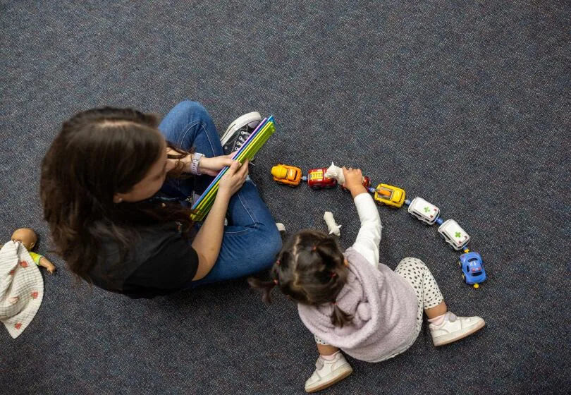 Pasadena, CA - April 18: Viviana Banuelos, teacher, left, plays with a child in the Early Head Start program at Pacific Clinics Early Head Start Center in Pasadena, Friday, April 18, 2025. Pacific Clinics in LA County has 7 centers serving about 500 kids. Head Start serves 800,000 low income children across the country, including 75,000 in California. It's not just child care - it's all around supports for families, including medical and dental screenings, mental health care, and job supports for parents. (Allen J. Schaben / Los Angeles Times)