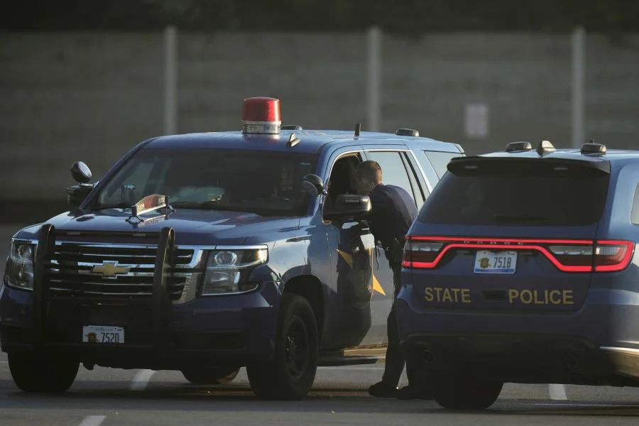 Law enforcement officers are seen stationed outside a Walmart where several people were stabbed in a violent attack Saturday, July 26, 2025, in Traverse City, Mich. (AP Photo/Ryan Sun)