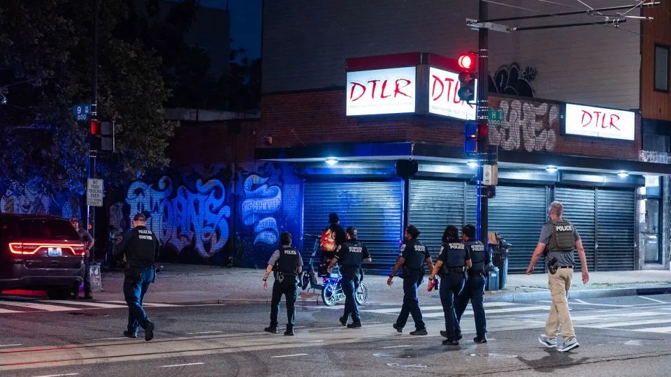 Metropolitan Police Department officers, MetroTransit Police Department officers and a federal officer leave an apartment building after responding to a call on H Street corridor in Washington, DC, on Wednesday. - Eric Lee for CNN