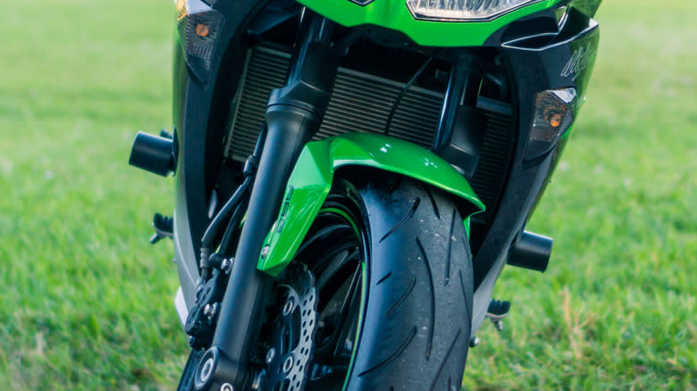 A sportsbike fitted with crash sliders on either side of the fairing.