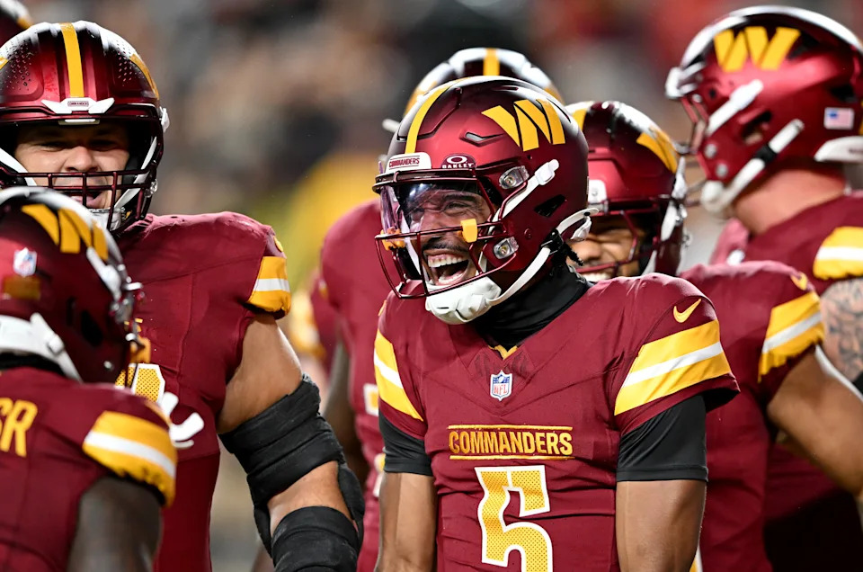 LANDOVER, MARYLAND - AUGUST 18: Jayden Daniels #5 of the Washington Commanders celebrates with teammates after rushing for a touchdown in the first quarter against the Cincinnati Bengals during the NFL Preseason 2025 game at Northwest Stadium on August 18, 2025 in Landover, Maryland. (Photo by G Fiume/Getty Images)