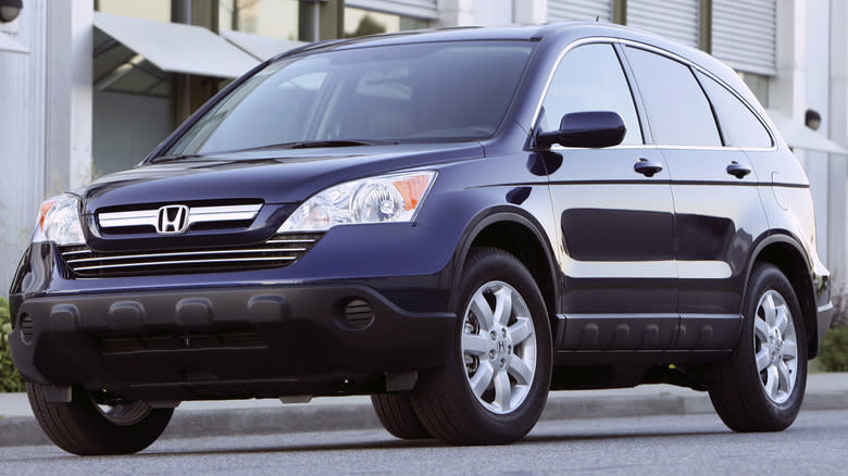 A blue 2007 Honda CR-V, parked in front of a building.