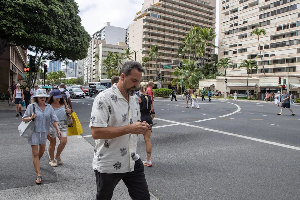 A man checks his mobile phone in Oahu, Hawaii on July 29, 2025, after an 8.7 earthquake off of Russia's far east prompted tsunami alerts. A powerful 8.7 magnitude earthquake off Russia's far east has prompted tsunami alerts across parts of the Pacific including Japan, Hawaii, Russia and Ecuador, and warnings along the California coast, US authorities said late on July 29. The massive temblor triggered warnings of waves up to three metres (10 feet) possibly hitting the coasts of Russia, Hawaii and even Ecuador and Chile along South America's west coast, according to the US Pacific Tsunami Warning Center based in Honolulu, Hawaii. (Photo by Eugene Tanner / AFP) (Photo by EUGENE TANNER/AFP via Getty Images)