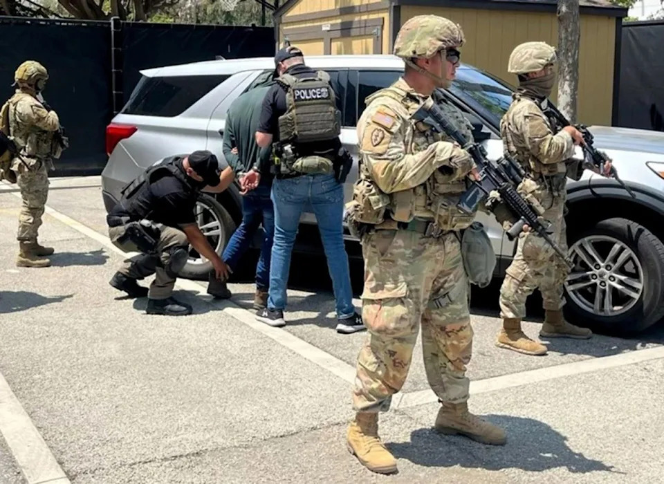 National Guard troops stand guard as federal agents make an immigration arrest in Los Angeles. - Photo via ICEgov on X
