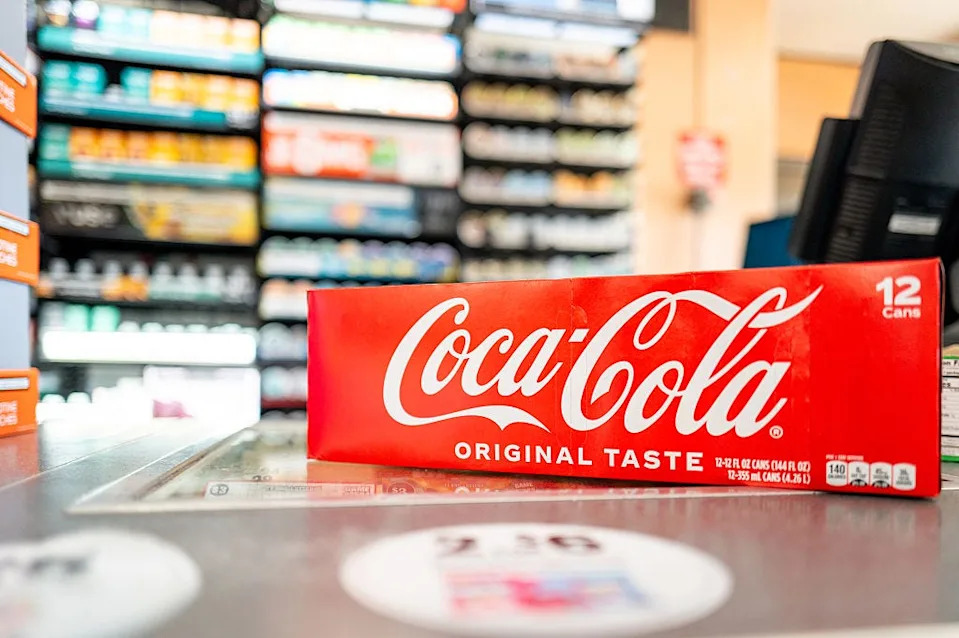 In this photo illustration, a 12-pack of Coke beverages is displayed on a counter in a 7-Eleven convenience store on July 17, 2025, in Austin, Texas.