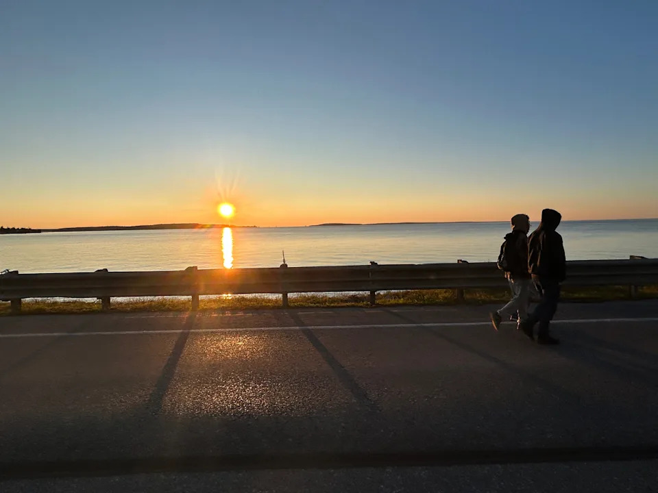 Walkers set out on the Mackinac Bridge Walk as the sun rises on Monday, Sept. 2, 2024.