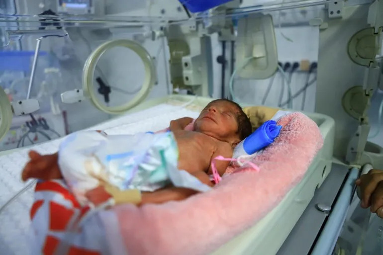 A premature baby lies in an incubator at Al-Helou Hospital, where doctors say a shortage of specialised formula milk is threatening the lives of newborns