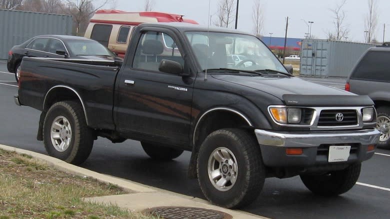A black single-cab 1996 Toyota Tacoma parked in a parking lot