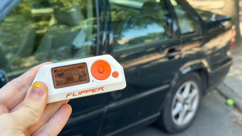 A Flipper Zero in front of a Volvo