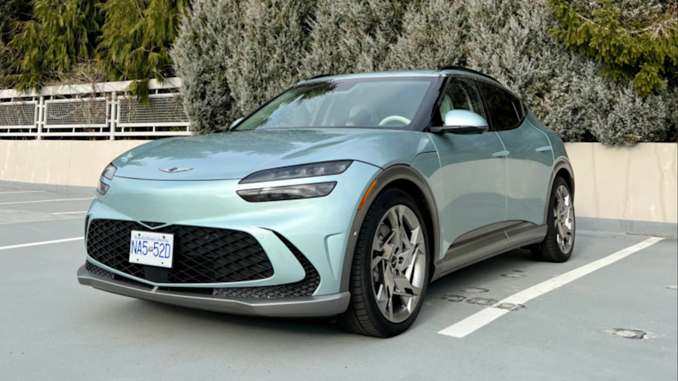 The Genesis GV60 in mint color paint in parking lot