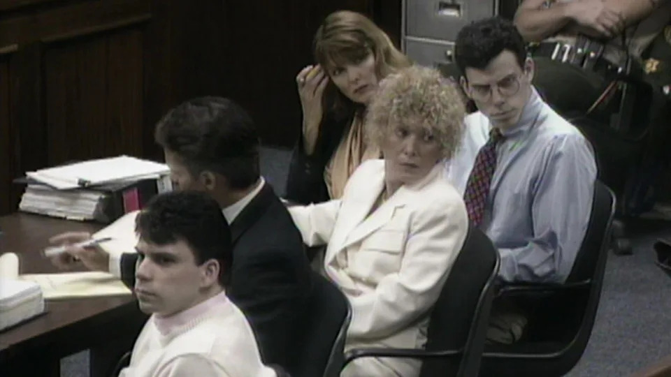 Lyle, left, and Erik Menendez sit in court with their attorneys during their first trial. / Credit: KCAL