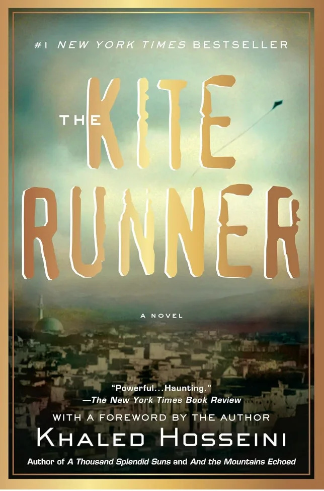 Cover of "The Kite Runner" by Khaled Hosseini, featuring a cityscape. Text highlights it as a #1 New York Times Bestseller and includes a review quote