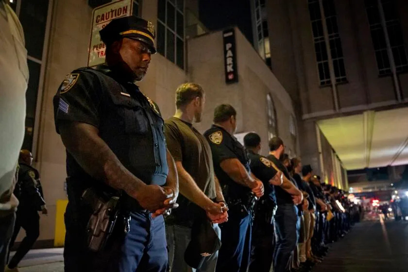 NYPD officers stand in line during the dignified transfer of Didarul Islam, who was shot and killed by a gunman Monday evening, out of NewYork-Presbyterian/Weill Cornell Medical Hospital to the medical examiner&#39;s office, early Tuesday, July 29, 2025, in New York. (AP Photo/Angelina Katsanis)